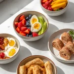 A selection of quick high-protein snacks including Greek yogurt with berries, cottage cheese, eggs with vegetables, peanut butter banana bites, and turkey roll-ups